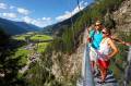 Hiker on suspension bridge in Längenfeld