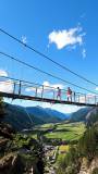 Hikers crossing Ötztal suspension bridge