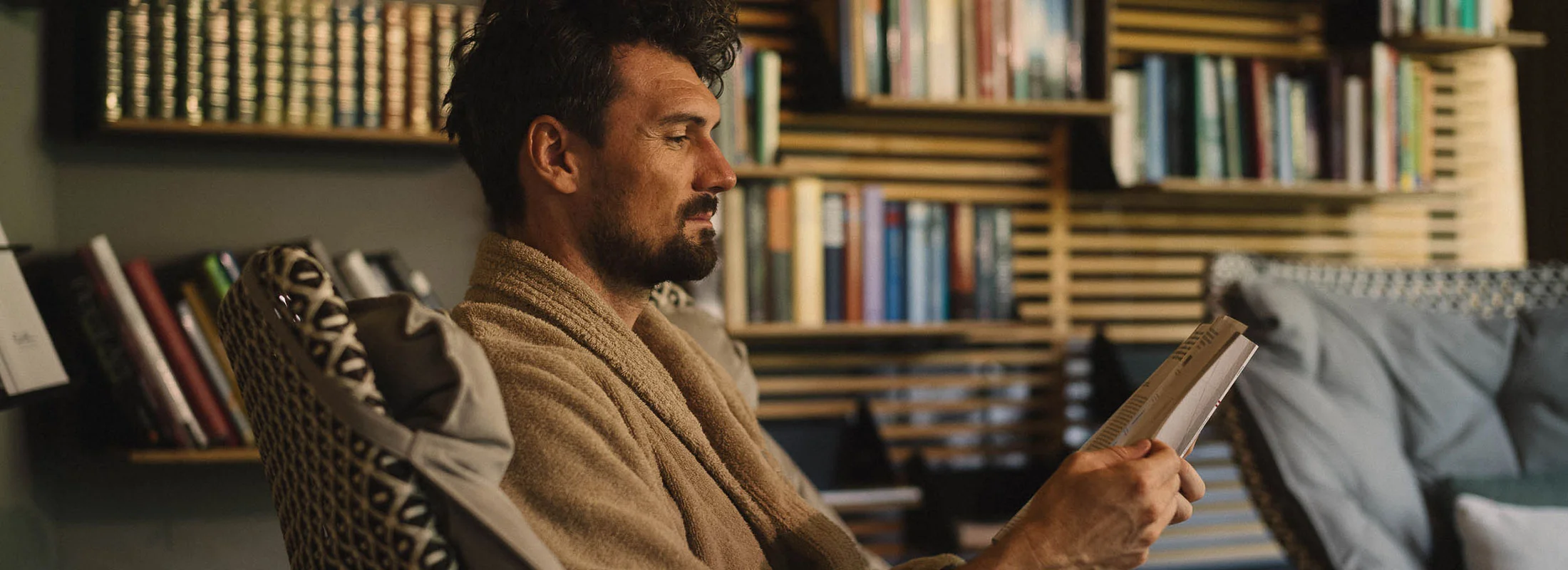 Man reading in a bathrobe at Naturhotel Waldklause, Ötztal Valley